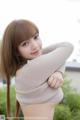 A young woman with long brown hair posing for a picture.